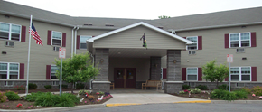 Rochester apartment for rent - the front of a building with a porch and two flags