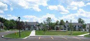 Farmington townhouse for rent - A large building with a parking lot in front of it.
