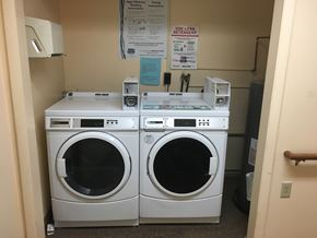 Rushville apartment for rent - a washer and dryer in the laundry room of a building