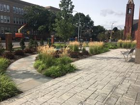 Rochester apartment for rent - a view of a park with a stone walkway and a bench