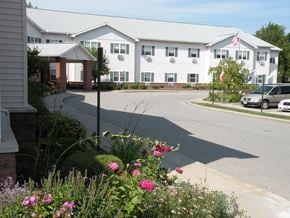 Rochester apartment for rent - the view of a large white building with a street in front of it