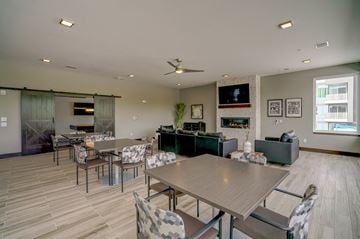 Madison apartment for rent - a dining room with tables and chairs and a living room with a television