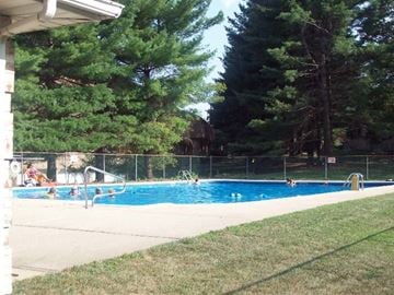 Mahwah apartment for rent - A group of people are in a pool on a sunny day.