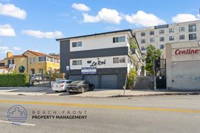 Los Angeles apartment for rent - A building with a sign that says Le Roi is in front of a building that says Conine.