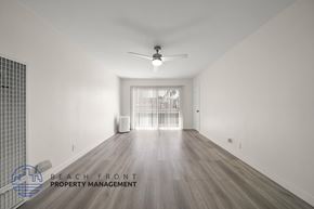 Los Angeles apartment for rent - A spacious room with a fan and a window with blinds.