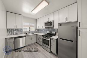 Los Angeles apartment for rent - A kitchen with stainless steel appliances and white cabinets.
