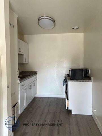 Anaheim apartment for rent - A kitchen with white cabinets and a black pot on the counter.