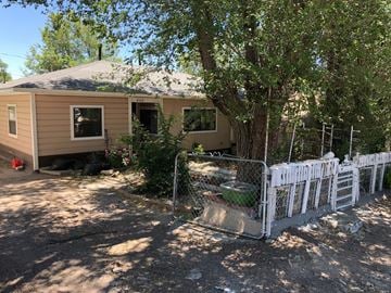 Flagstaff house for rent - a house with a fence and a tree in front of it