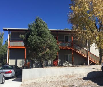 Flagstaff apartment for rent - an exterior view of a building with cars parked in front of it