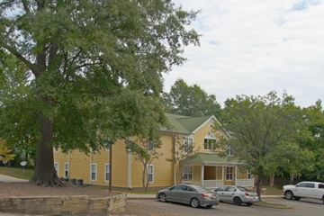 Durham apartment for rent - A yellow house with a tree in front of it.