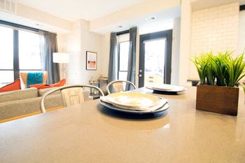 Kitchen plates on quartz countertops in confluence on 3rd apartments in des moines in downtown des moines