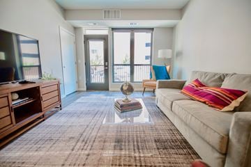 Des Moines apartment for rent - a living room with a couch and a tv and a balcony