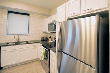 Stainless steel appliances in kitchen at confluence on 3rd apartments in des moines in downtown des moines