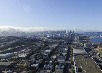 Rooftop deck with bay and city views, cabanas, lounging and dining spaces and barbecue grill