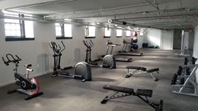 Philadelphia apartment for rent - A gym with a variety of exercise equipment including treadmills, stationary bikes, and weight machines.
