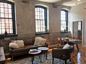 Philadelphia apartment for rent - A living room with a brown couch, a coffee table, and a rug.