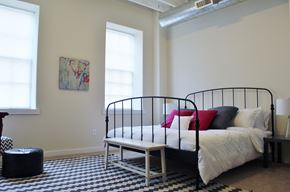Philadelphia apartment for rent - a bedroom with a bed and a black and white checkered rug