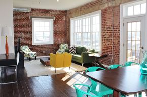 Philadelphia apartment for rent - a living room with a table and chairs and a brick wall