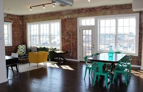 Philadelphia apartment for rent - a living room with a table and chairs and a brick wall