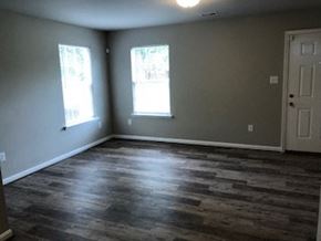 Lexington apartment for rent - an empty living room with wood floors and a door