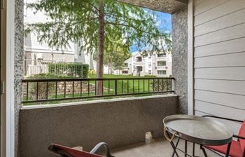 Full-length sliding glass windows leading to private patio or balcony