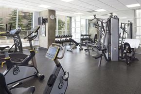 Calgary apartment for rent - fitness facility with exercise bikes, weights and other exercise equipment.