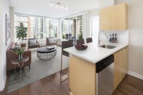 Vancouver apartment for rent - a kitchen and living room with a table and chairs and a couch