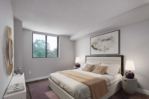 Toronto apartment for rent - bedroom with white walls and a large bed with white sheets and pillows
