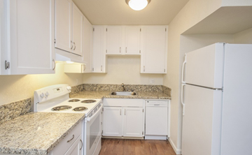 Fairfield apartment for rent - A kitchen with white cabinets and granite countertops.