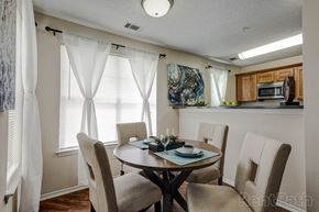 Denver apartment for rent - a dining room with a table and chairs and a kitchen