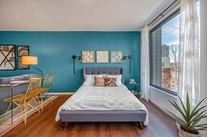 Boston apartment for rent - a bedroom with a bed and a large window