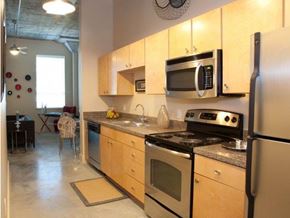 New Orleans apartment for rent - a kitchen with stainless steel appliances and wooden cabinets