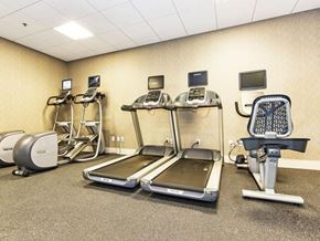 Dallas apartment for rent - a gym with various exercise equipment in it