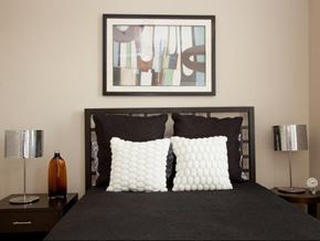 New Orleans apartment for rent - a bedroom with a black bed and a picture on the wall