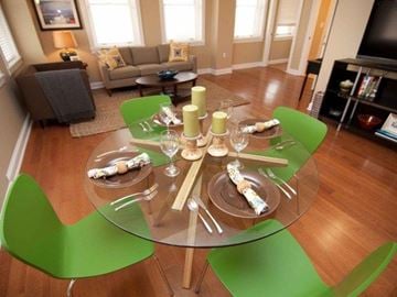 Jackson apartment for rent - a glass table with green chairs in a living room
