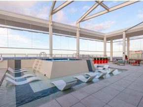 New Orleans apartment for rent - a swimming pool on the top of a building with chairs