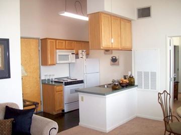 Shreveport apartment for rent - A kitchen with wooden cabinets and a white fridge.