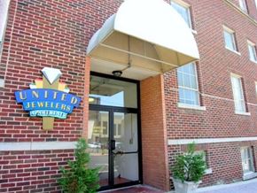 Shreveport apartment for rent - The entrance to United Jewelers with a brick wall and a white awning.