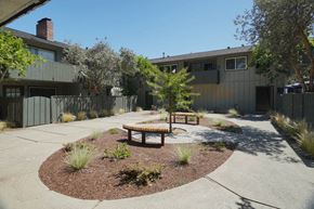 Sunnyvale apartment for rent - a courtyard with a bench and a tree in front of a house