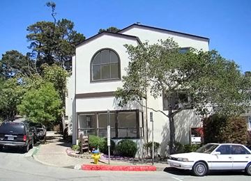 Carmel apartment for rent - a white building with cars parked in front of it