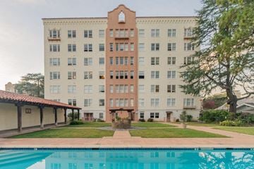 Palo Alto apartment for rent - a large building with a pool in front of it