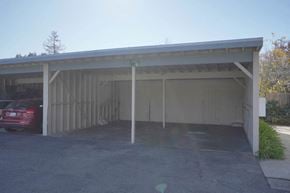 Palo Alto triplex for rent - a white garage with a red car parked in it
