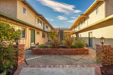 Sunnyvale apartment for rent - a courtyard between two buildings with a blue sky in the background