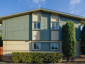 Mountain View apartment for rent - a green and white house with a tree in front of it