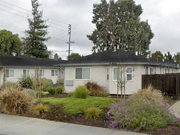 Palo Alto apartment for rent - A row of houses with a green lawn in front.