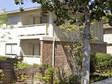 Palo Alto apartment for rent - a white and brick house with a tree in front of it