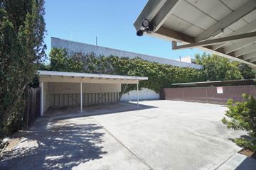 Palo Alto apartment for rent - an empty parking lot with a building in the background