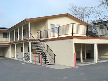 Palo Alto apartment for rent - a building with stairs and a bike parked in front of it