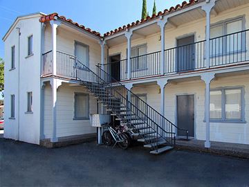 Menlo Park apartment for rent - a building with a staircase and a bike parked in front of it