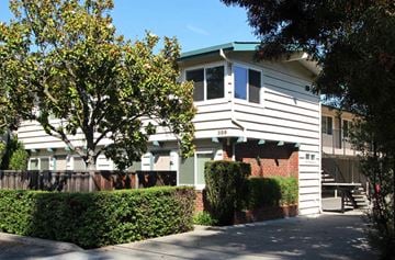 Palo Alto apartment for rent - a white house with a blue roof and hedges